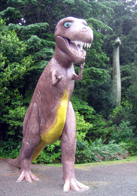 The mighty tyrannosaurus, with a brontosaurus hiding in the bushes behind him.